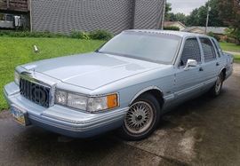 Ride in comfort and style with this 1991 Lincoln town car. This vehicle comes in a light blue with grayish blue interior. This item features power locks power doors power seat, am FM radio, tape deck, V8 overhead Cam engine. The miles on his vehicle are 119,655.  Currently this vehicle is in running condition but has not been taken outside of neighborhood roads. It has been sitting for a couple years and will need fresh gas. There are some nicks and dings in the exterior to include  Yellow paint on the passenger side a Dang in the rear passenger side bumper, crack and the we're passenger side Light and the trunk key emblem cover is missing.  For further information on this vehicle the Vin number is ILNCM82WOMY679336. Please see pictures and video for further details.  There will be several opportunities to view this vehicle in person. 