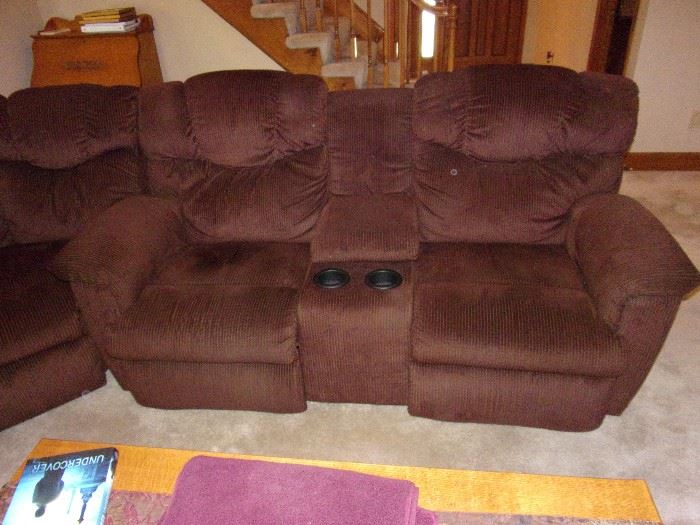 Sectional couch with reclining seats (4) on each end. Pictured is love seat with center cup holders and storage bin in the middle.