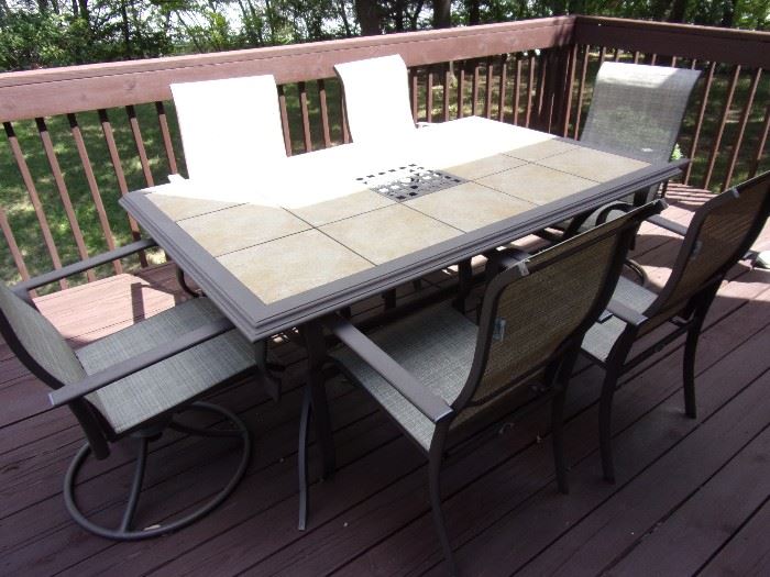 Hampton Bay
Belleville 7-Piece  Outdoor Dining Set
Includes 39.5 in. x 64 in. table and 6 chairs ( swivel)
Bronze powder-coated frames & fabric is weather-resistant
Heavy-duty ceramic tile tabletop is durable and easy to clean
