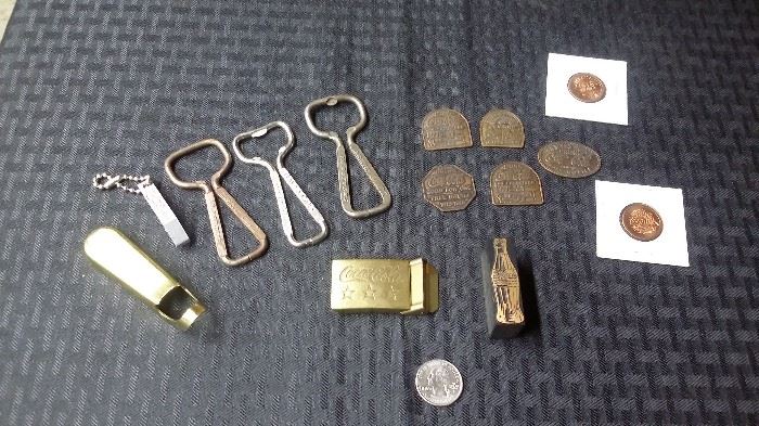 Coke bottle openers, belt buckle, stamp, coins, and tokens for "one free coke".