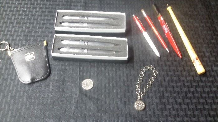 Coke key ring pouch, pens and bottle cap bracelet.