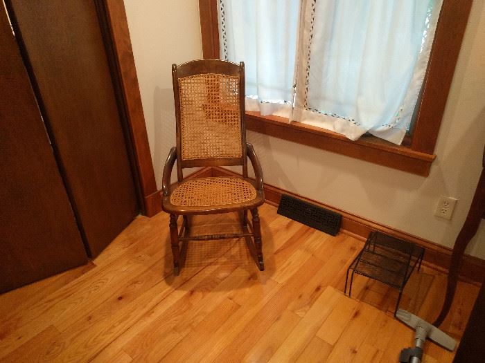 Antique caned rocking chair.