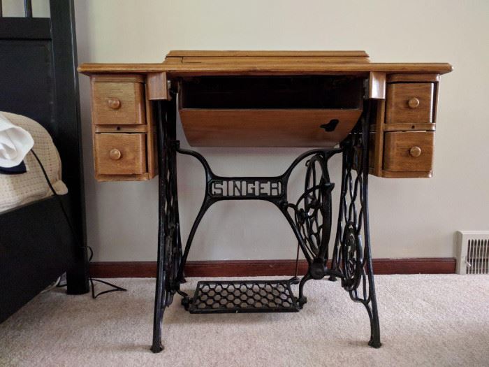 Antique Singer sewing machine cabinet. No machine inside. Great conversation piece. Perfect for the person who hates to sew! Many Singer machines will actually fit.