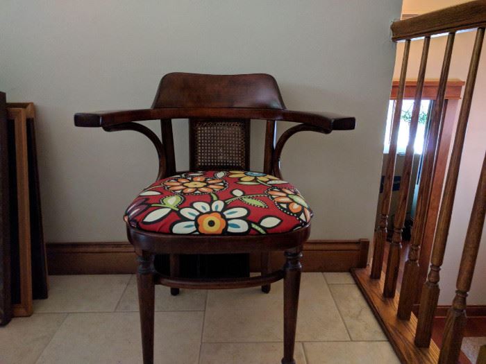Upholstered wood arm chair with cane inset. Original finish.