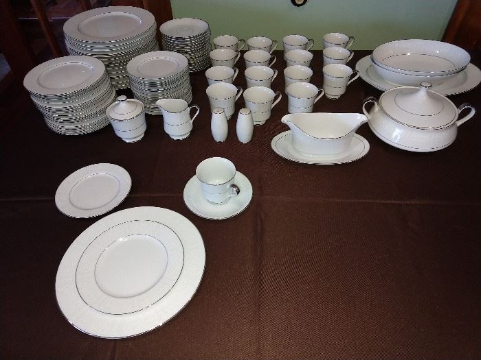 16 place settings of china, with serving pieces.