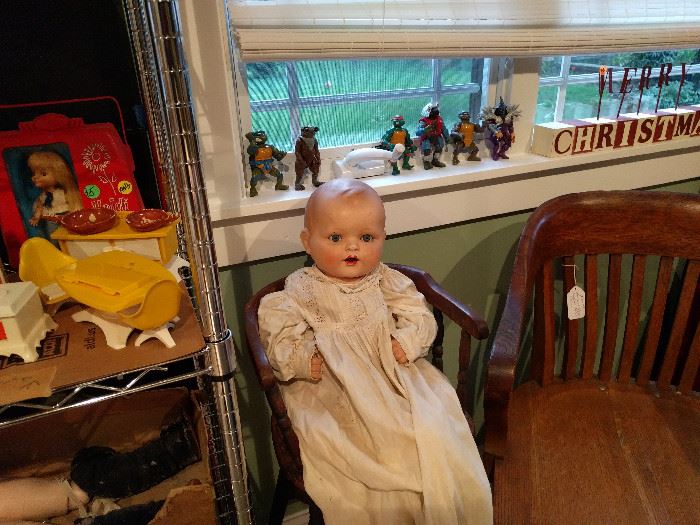 Baby doll from late 20s/early 30s. She has been well-loved, and shows it. She's still my favorite though. She is sitting in an antique high chair.