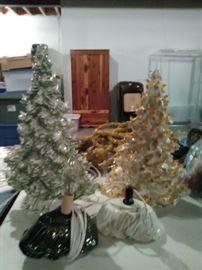 Ceramic lighted Christmas trees and Cedar storage cabinet in back