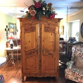 Beautiful carved pine storage armoire measures 44" wide, 78" high and 25" deep. 