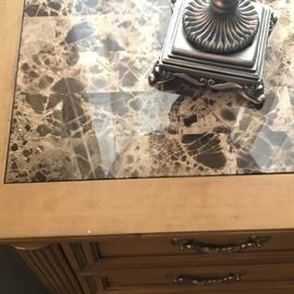 Marble inlaid top of nightstands.
