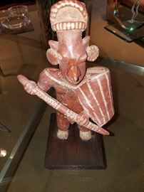 JALISCO TERRACOTTA WARRIOR, TALA-TONALA STYLE, THE STANDING FIGURE OF 'SHEEPS FACE' TYPE HOLDING A CLUB AND SHIELD   DATED 100BC - 250 AD