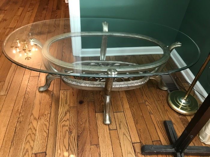 #16		Glass Oval Coffee Table w/Heavy Scroll Bottom  52x30x19	 $75.00 
