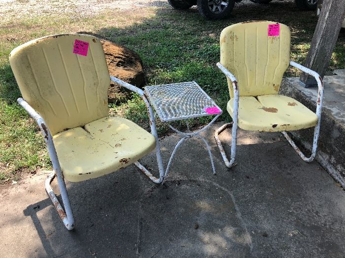 Vintage metal lawn chairs and a mid century metal mesh top patio end table