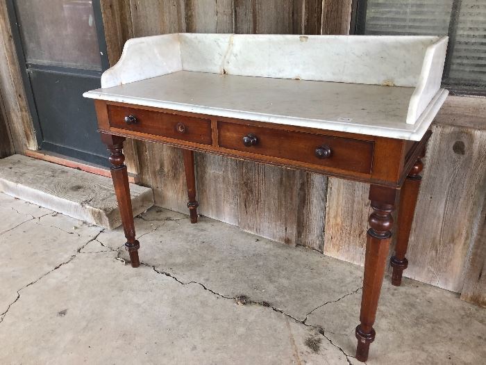 Antique early Victorian wash stand with marble top and original wood pull nobs, which one is missing. Circa 1860