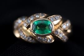 Oval Shaped Bezel Garnet with accenting Diamonds set in 18K Gold