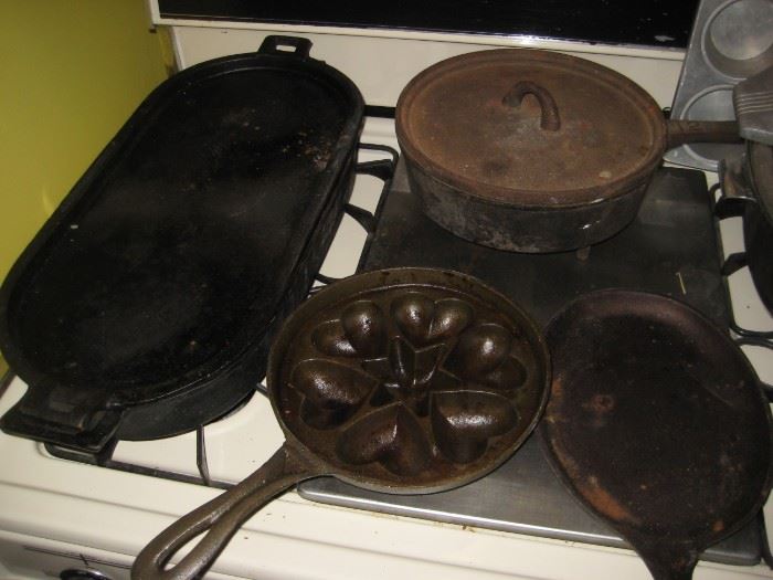 Cast iron pans, dutch oven  and cornbread  molds. 