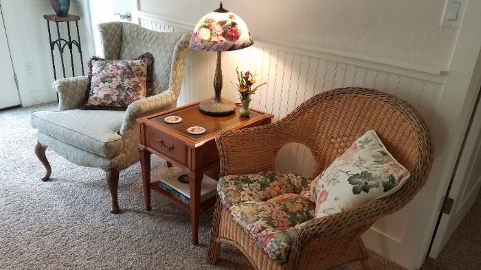 Wingback Chair. Several Side Tables. Wicker Chairs. Decorator Pillows. Glass Shade Lamp. 