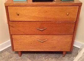 There are two of these Mid-Century chests. In the one shown, the second drawer needs repair.
