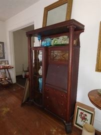 Well now Arts & Crafts showcases the original Home Office. Beveled Mirror & Glass enclosed Curio/Book Case, Fold Down Writing Desk with cubbies, three drawers for storage and shallow enough for a wide foyer. Organization has never been more functional or lovely.   