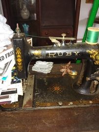 Ruby don't take your love to town. Awesome arts and crafts sewing machine with original cast iron abstract stand. 