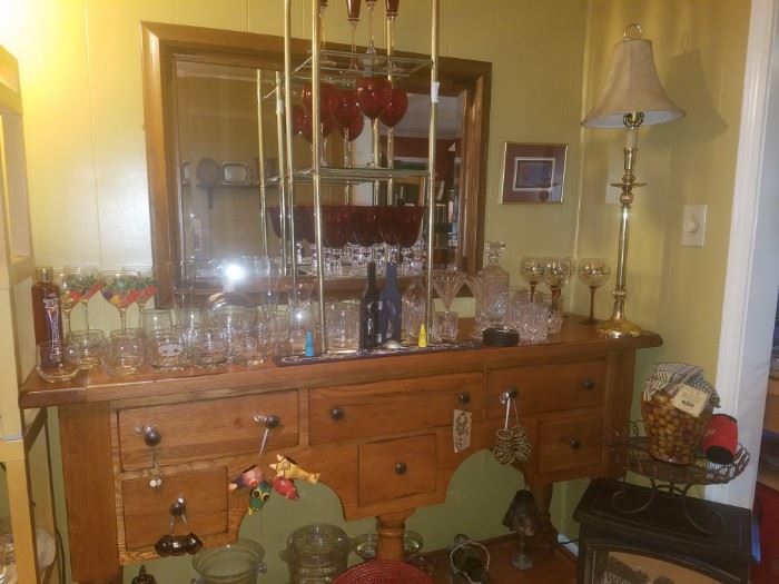 Bar/buffet with glasses, decanters, brass lamp, mirror, & more. Glasses including Pfaltzgraff Winterberry wine glasses, Lenox red wine glasses, crystal martini glasses, & more.