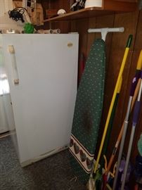 Small upright freezer, ironing board, mops/brooms, & more.