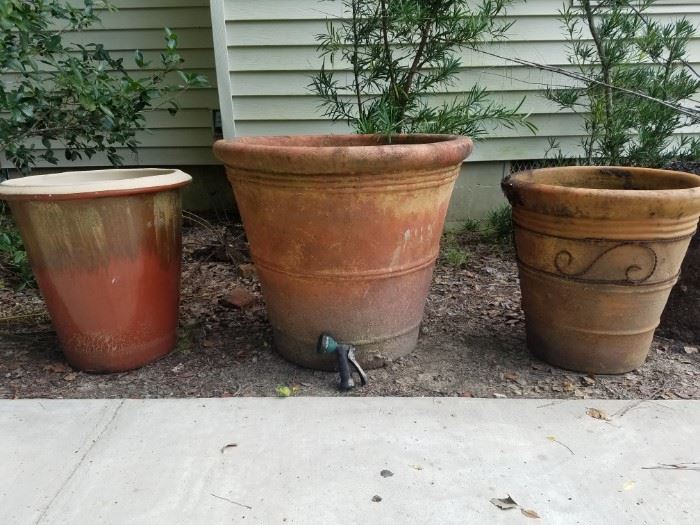 Large flower pots (notice the water hose sprayer for size reference)
