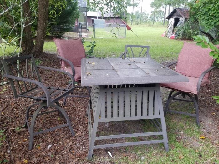 High top outdoor table & 4 swivel stools. 