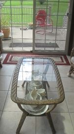 Glass top rattan table,, on patio--- one of 3 vintage painted red outdoor chairs