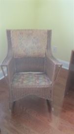 Antique wicker rocking chair with original covering