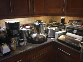 assorted stainless kitchen appliances, Breville toaster oven, Bunn coffee maker, Food Saver, Omega juicer