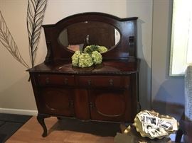 Antique mahogany? sideboard with cabriolet legs and original oval mirror backdrop measures  4' across. left upper drawer is lined for silver.