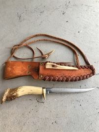 Handmade fish fillet knife with scrimshaw antler handle and leather scabbard. 