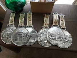 WMF PEWTER WALL PLAQUES (6) DIFFERENT ONES. MADE IN GERMANY. EACH HANGING FROM A TAPESTRY RIBBON IS 13" LONG