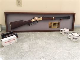 Henry rifle with display, mugs, and ammunition
