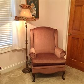 Upholstered chair and antique floor lamp