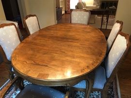 Baker Furniture hand carved dining room table with 6 chairs. Auction lot also includes 2 leaves for table.