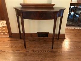 Wooden entry table with gold colored trim 
