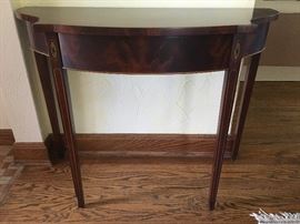 Wooden entry table with gold colored trim