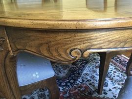 Hand carvings on side of dining room table