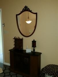 Crest Mahogany Mirror shown with credenza, curio, candle lamp and porcelain church.