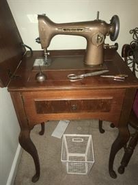 Vintage sewing machine in cabinet