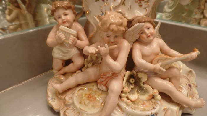 mirror with cherubs playing musical instruments.approx. 15 " high....