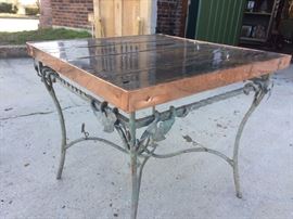 Locally hand crafted table with old iron green metal base, wood top sealed with poly, and copper edging also sealed to keep it's color.  25.5"W x 25.5"W x 24" H  $275