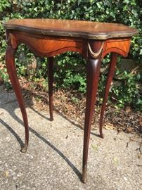 Petite french style table with pretty decorative brass accents around edge and feet. Top could use refinishing.  22"W x 14.4"D x 26.5"H $225