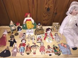 A large variety of antique dolls. Large one is handmade, smaller ones are from various locations and time periods. Many are porcelain. Pricing varies
