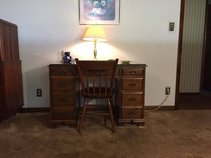 Smaller sized solid wood desk with chair and glass top.  Dimensions 30" height x 32" width x 22" depth.  Very good condition.