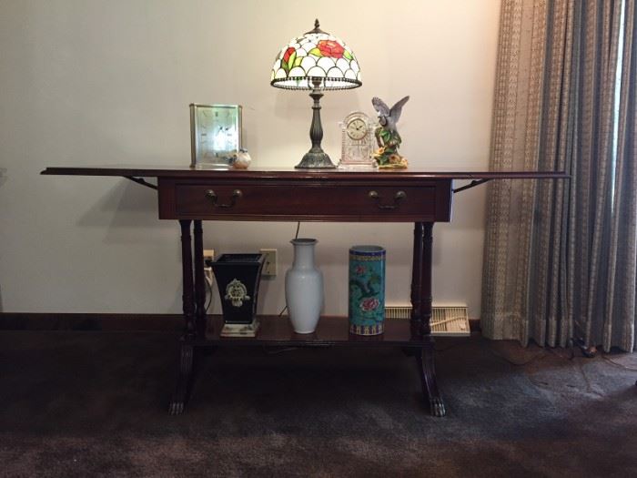 1950's / 1960's sold wood drop leaf table with single shelf.  Dimensions when leaves are open 28" height x 57" width x 24" depth.  Excellent condition.