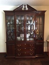 Ethan Allen "Georgian Court" cherry china cabinet/breakfront.  3 drawers (1 with silverware tray) and 2 side cabinets with shelving.  4 beveled glass doors.  Interior lighting.  Interior wood and glass shelving.  Dimensions are 86" height x 63" width x 14" depth.  Excellent condition. 