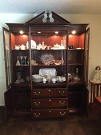 Ethan Allen "Georgian Court" cherry china cabinet/breakfront.  3 drawers (1 with silverware tray) and 2 side cabinets with shelving.  4 beveled glass doors.  Interior lighting.  Interior wood and glass shelving.  Dimensions are 86" height x 63" width x 14" depth.  Excellent condition. 