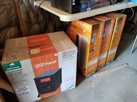 a dozen small space heaters new in box